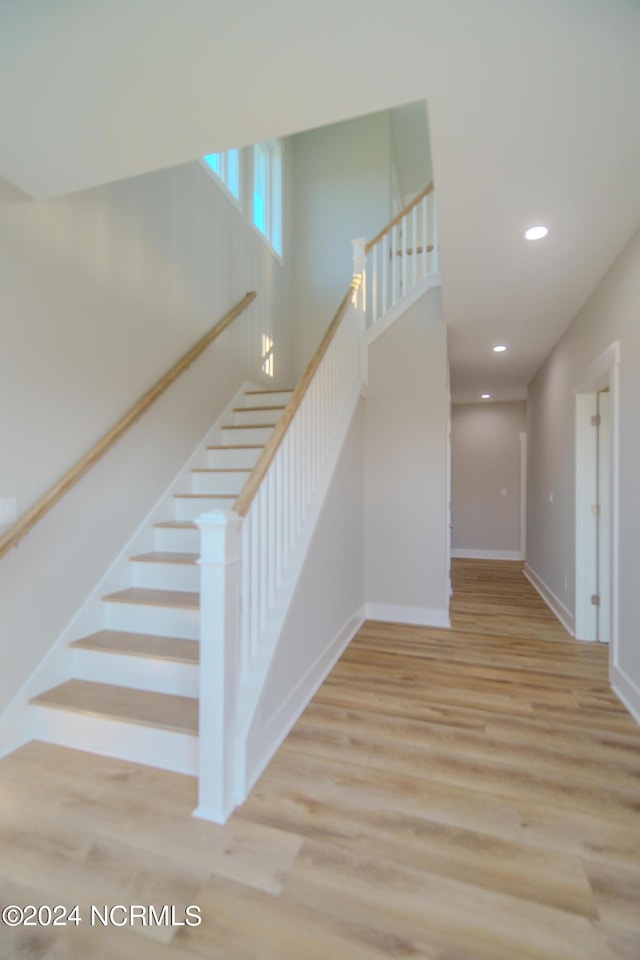 staircase featuring wood-type flooring