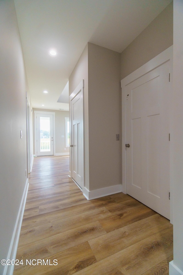 hallway with light wood-type flooring