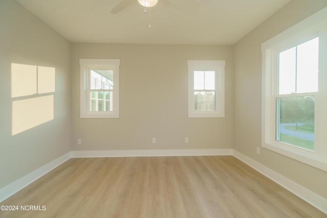 unfurnished room with light wood-type flooring, ceiling fan, and plenty of natural light