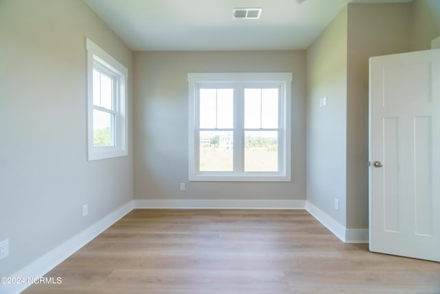 unfurnished room with light wood-type flooring and plenty of natural light