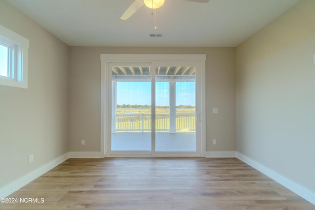 spare room featuring light wood-type flooring and ceiling fan