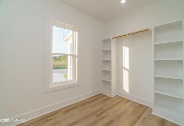 walk in closet with light wood-type flooring