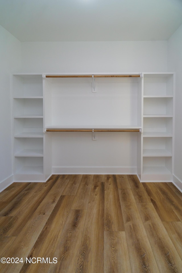 spacious closet featuring hardwood / wood-style flooring