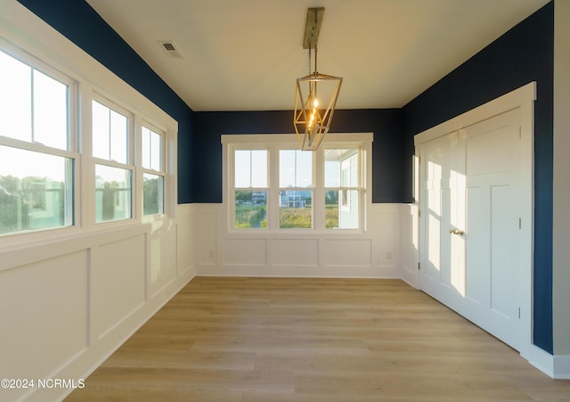 unfurnished dining area with light wood-type flooring