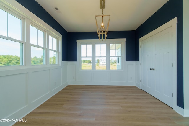 unfurnished dining area with light wood-type flooring and plenty of natural light