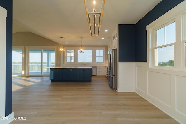 kitchen with light wood-type flooring, a chandelier, and a healthy amount of sunlight