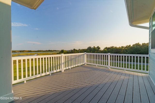 wooden terrace with a lawn