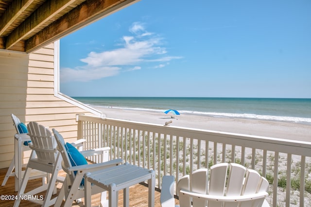 balcony with a view of the beach and a water view