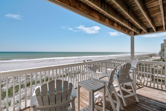 deck with a view of the beach and a water view