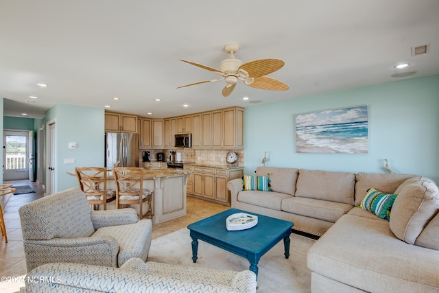 tiled living room featuring ceiling fan