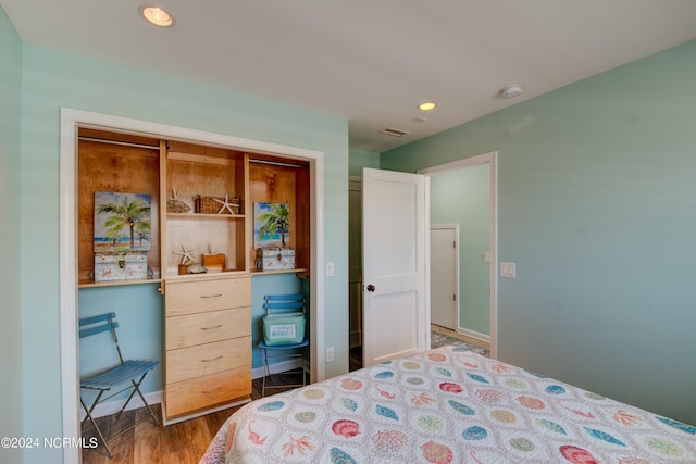 bedroom featuring a closet and dark hardwood / wood-style flooring