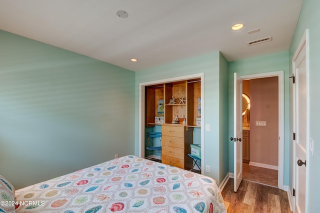 bedroom with a closet and hardwood / wood-style floors