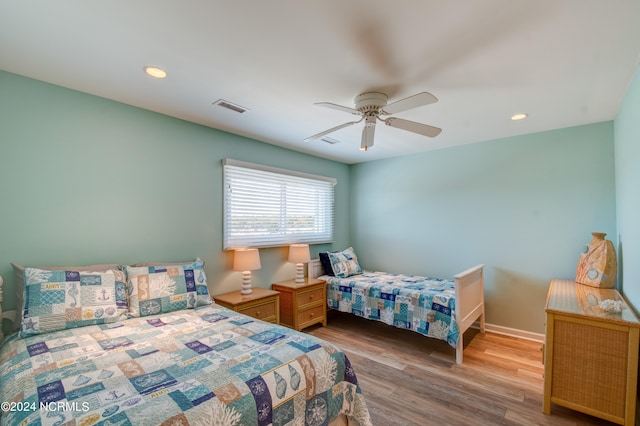 bedroom with ceiling fan and light hardwood / wood-style floors