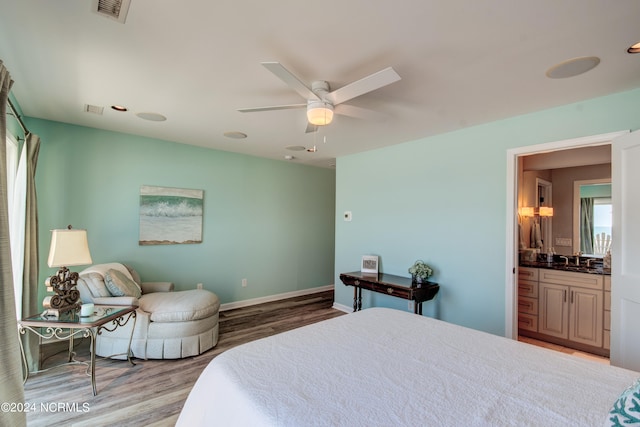 bedroom featuring connected bathroom, ceiling fan, and light hardwood / wood-style flooring