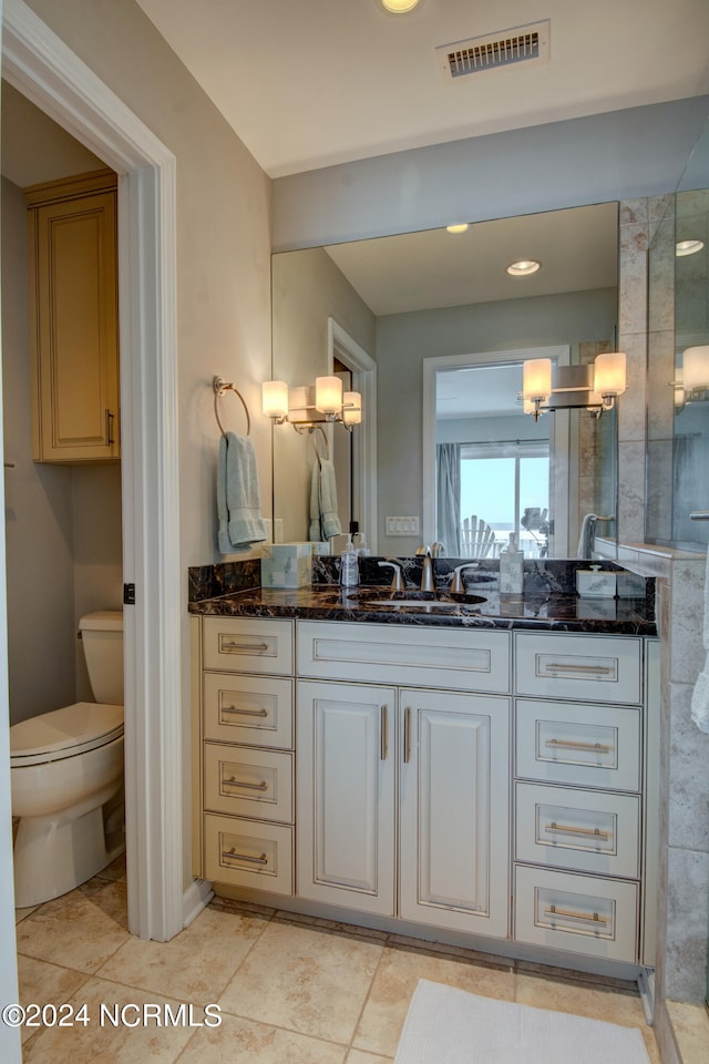 bathroom featuring tile patterned floors, a shower, vanity, and toilet