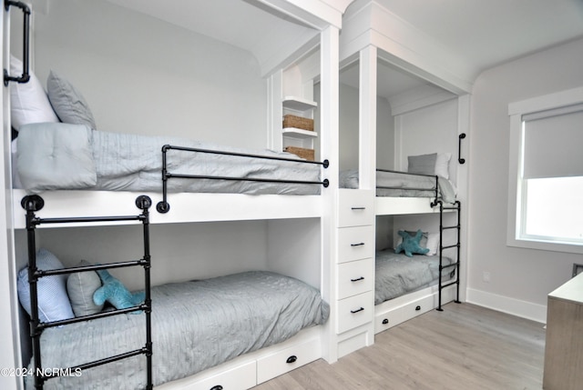 bedroom featuring wood finished floors and baseboards