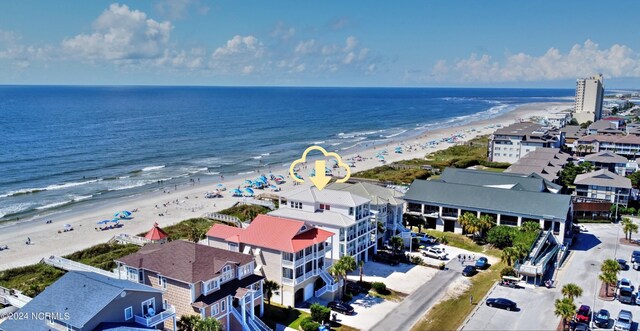 bird's eye view with a water view and a beach view