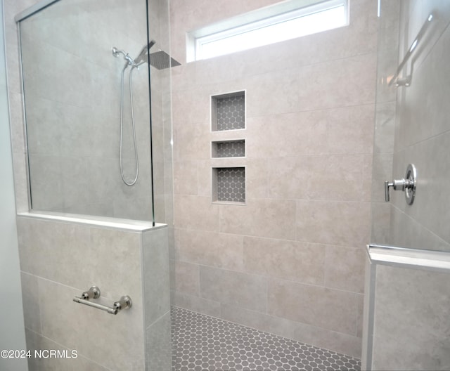 bathroom with a tile shower