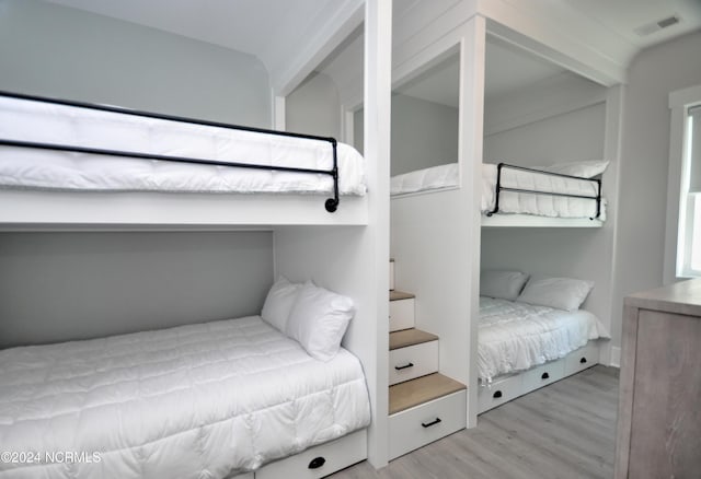 bedroom featuring visible vents and wood finished floors