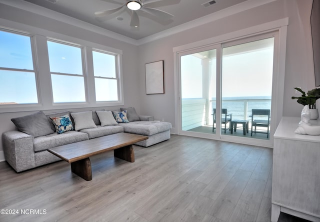 living room with light hardwood / wood-style flooring, a water view, ceiling fan, and ornamental molding