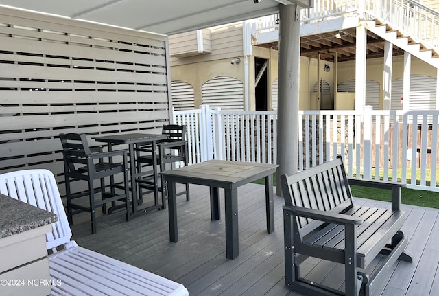 wooden deck featuring outdoor dining area