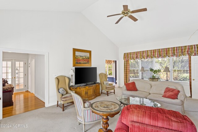 living room with high vaulted ceiling, ceiling fan, light carpet, and french doors