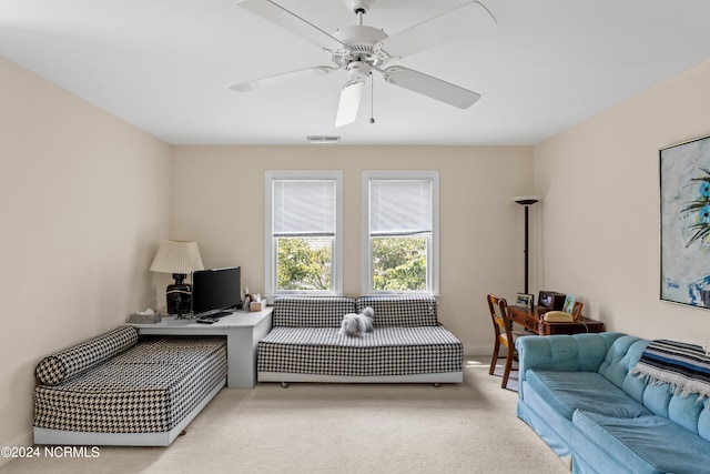 living room with ceiling fan and carpet