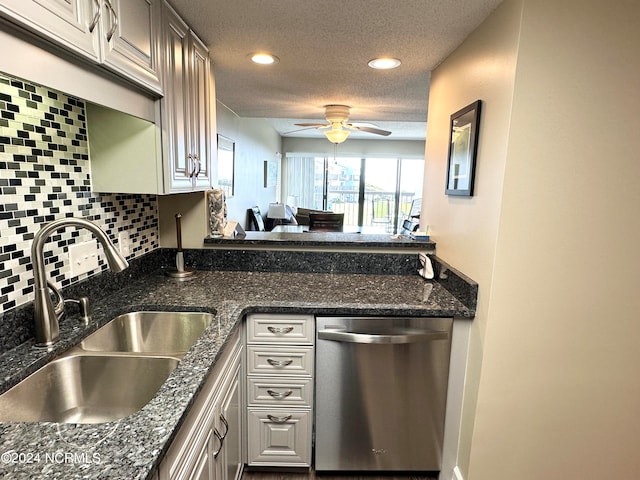 kitchen with a textured ceiling, dishwasher, sink, decorative backsplash, and ceiling fan