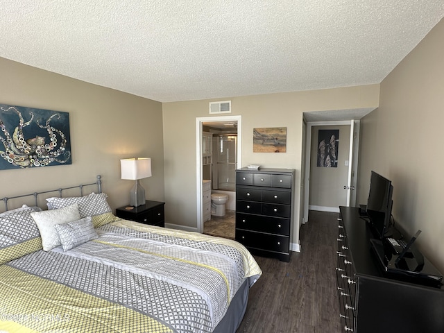 bedroom featuring baseboards, visible vents, ensuite bath, dark wood-style flooring, and a textured ceiling