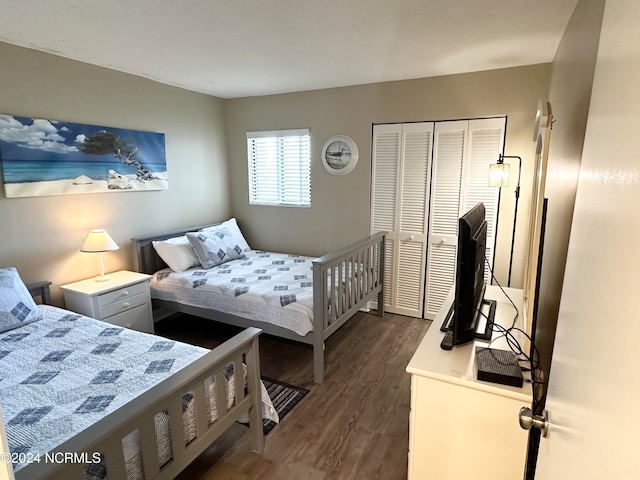 bedroom featuring a closet and dark hardwood / wood-style floors