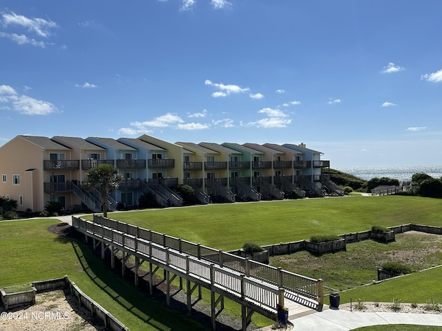 view of home's community featuring a residential view and a yard