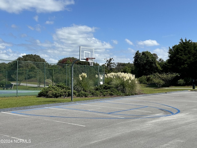 view of basketball court with community basketball court and fence