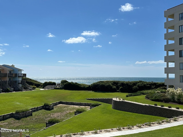 surrounding community featuring a lawn and a water view