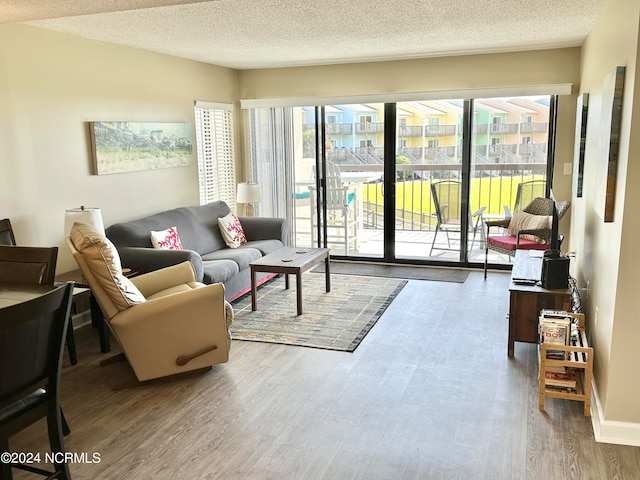 living room featuring hardwood / wood-style flooring and a textured ceiling