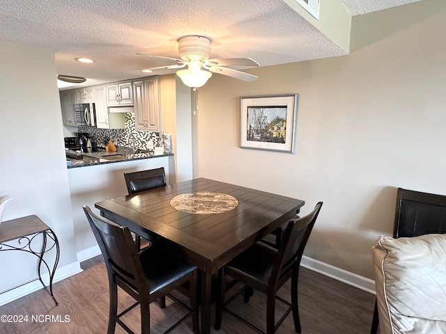 dining space featuring a textured ceiling, ceiling fan, and hardwood / wood-style floors