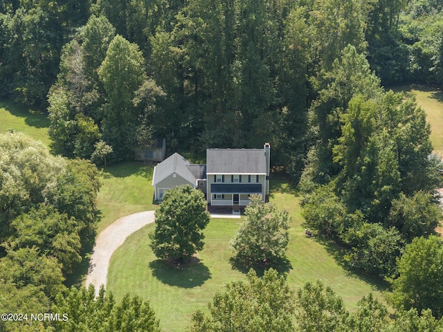 birds eye view of property featuring a wooded view