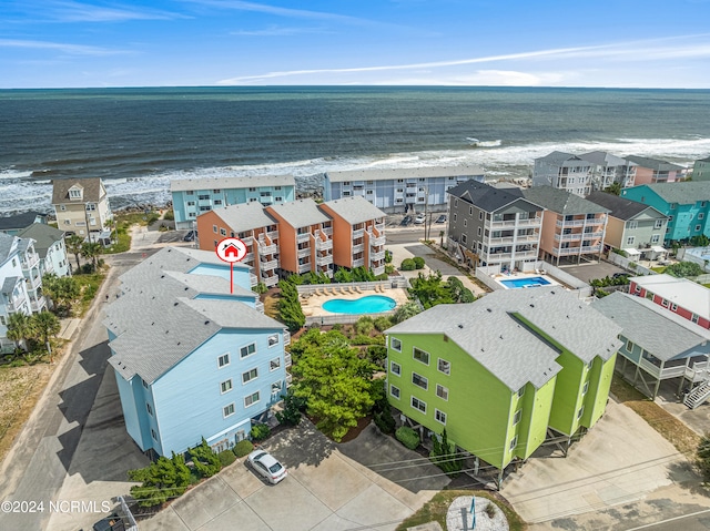 drone / aerial view featuring a beach view and a water view