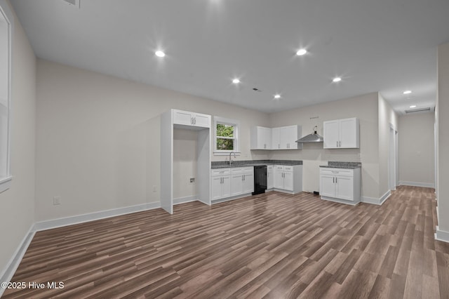 kitchen with hardwood / wood-style floors, white cabinetry, black dishwasher, and exhaust hood