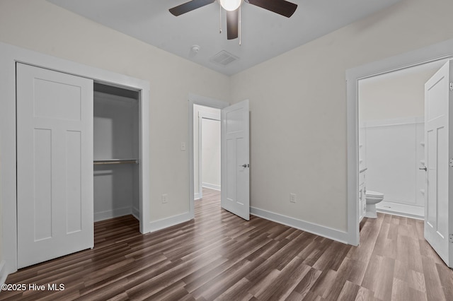 unfurnished bedroom with ceiling fan, dark hardwood / wood-style flooring, ensuite bathroom, and a closet