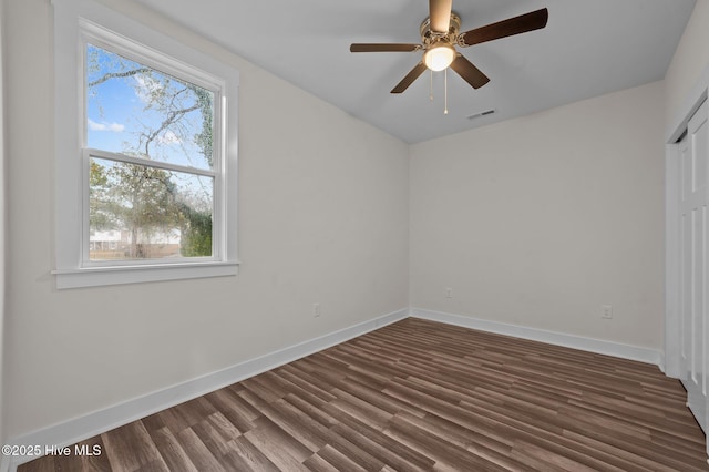 empty room featuring dark hardwood / wood-style floors and ceiling fan