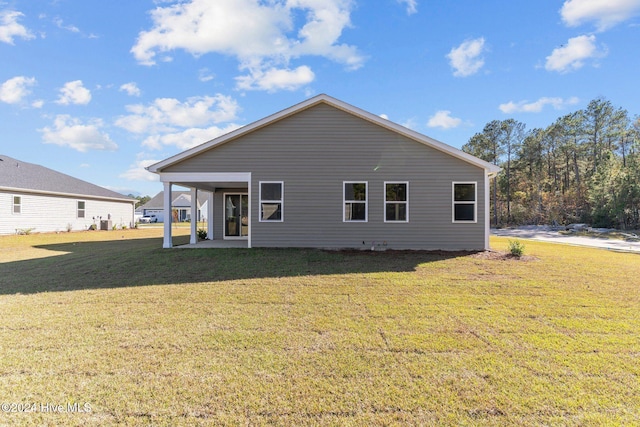 rear view of property with a yard