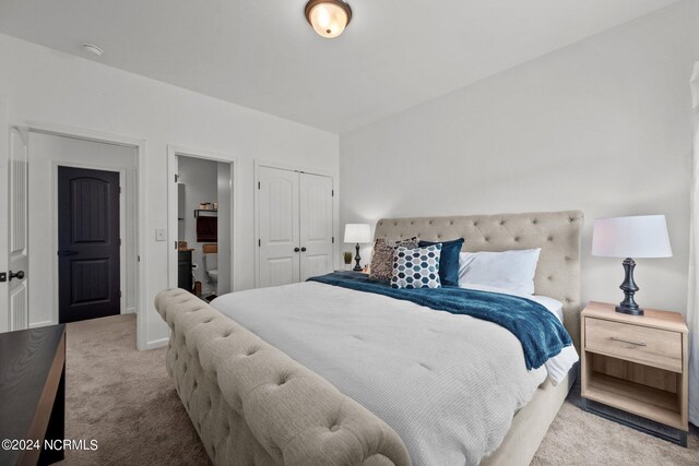 bedroom featuring light colored carpet and a closet