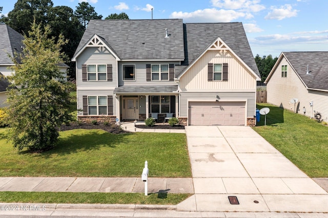 view of front of home featuring a garage, a porch, and a front yard