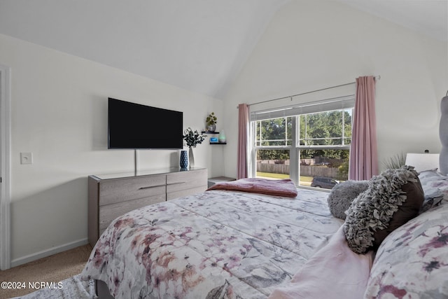 carpeted bedroom with baseboards and high vaulted ceiling