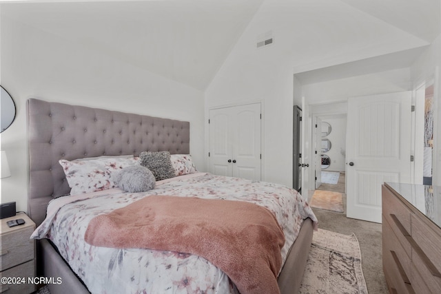 carpeted bedroom featuring high vaulted ceiling, a closet, and visible vents