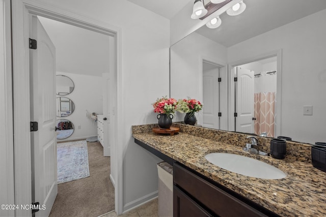 full bath with baseboards and vanity