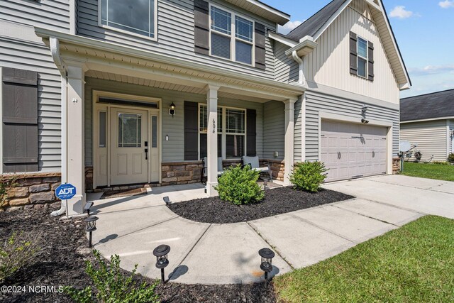 exterior space with a porch and a garage