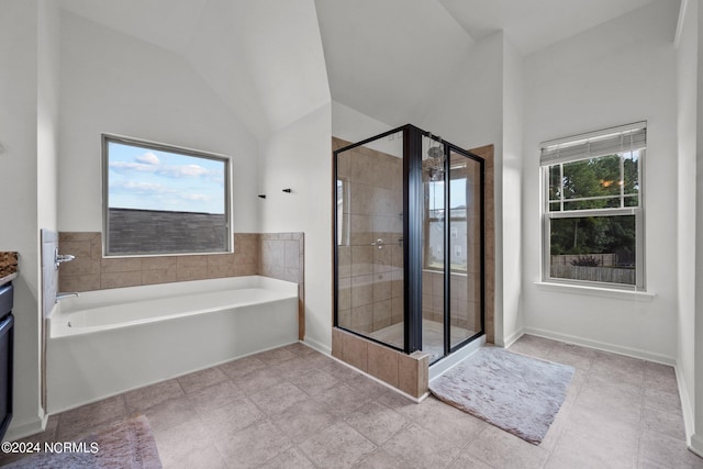 bathroom with a wealth of natural light, plus walk in shower, and lofted ceiling