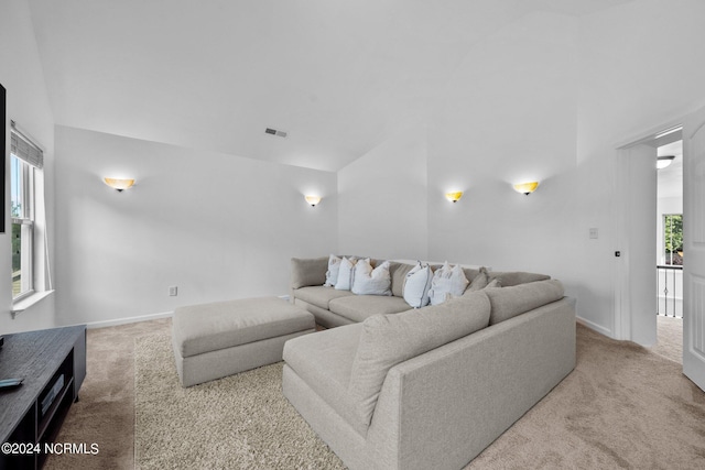 carpeted living area featuring visible vents and baseboards