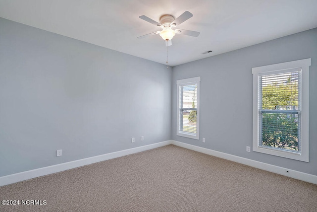 empty room featuring ceiling fan and carpet floors